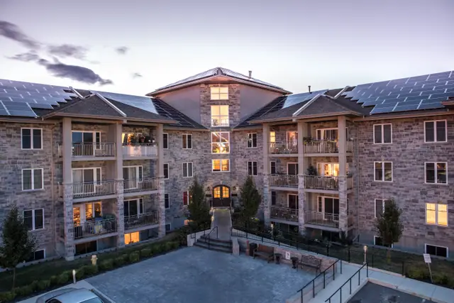 Stone courtyard at dusk with solar roofs